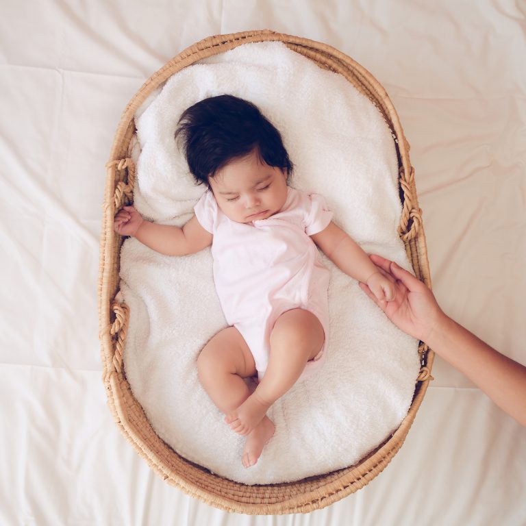 Baby sleeping in a basket